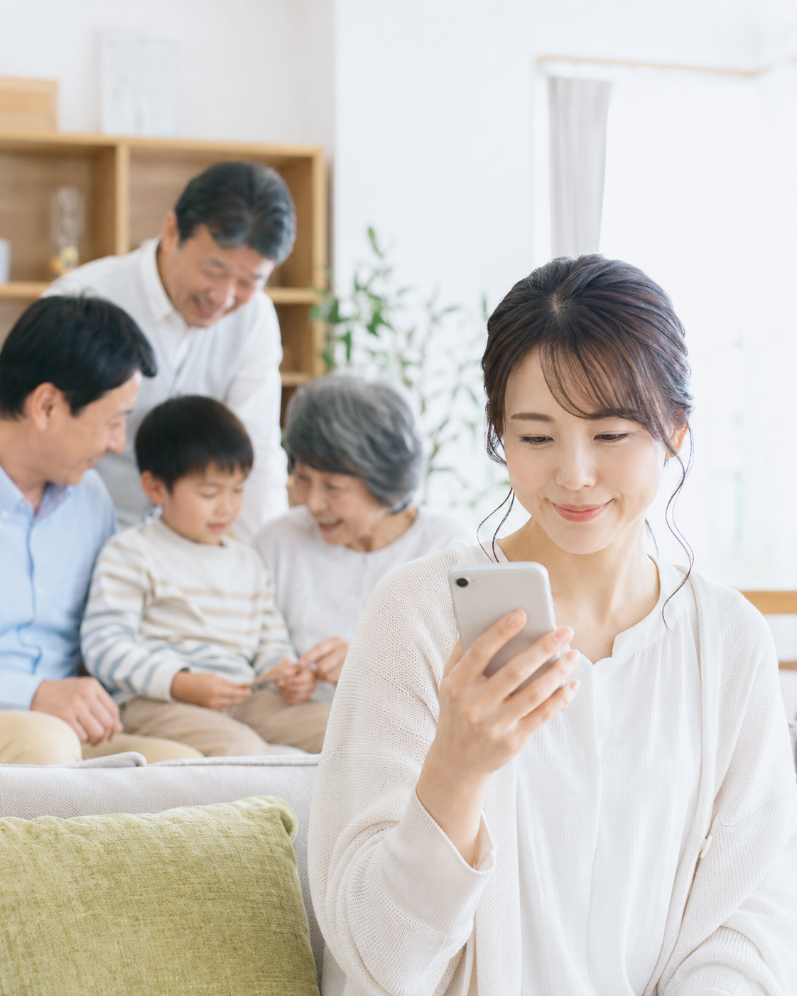 スマートフォンを確認する3世代家族